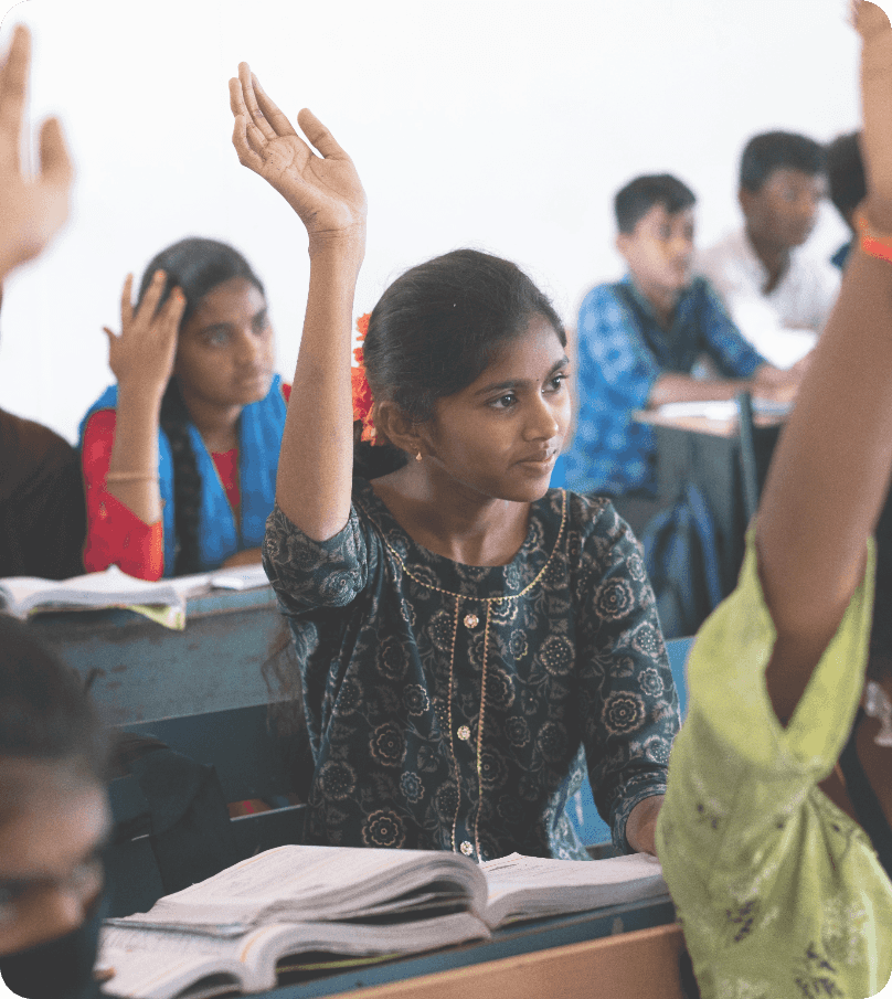 Students raising hands in classroom